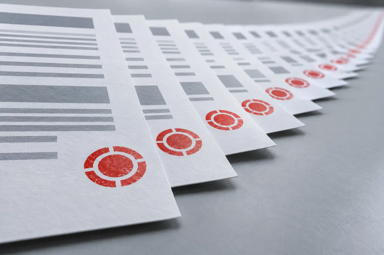 A long row of identical forms, each carrying the same red stamp, receding into the distance